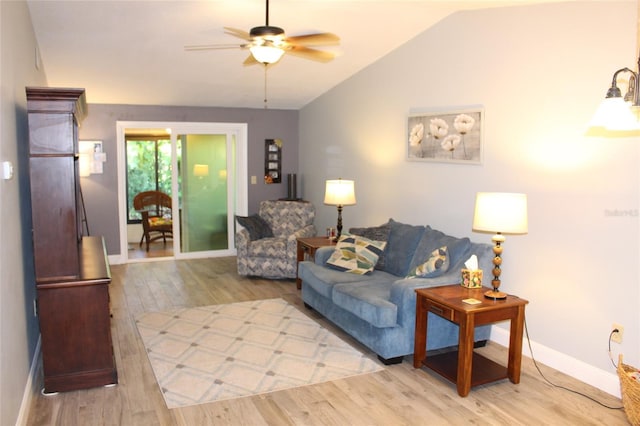 living room featuring baseboards, wood finished floors, ceiling fan, and vaulted ceiling