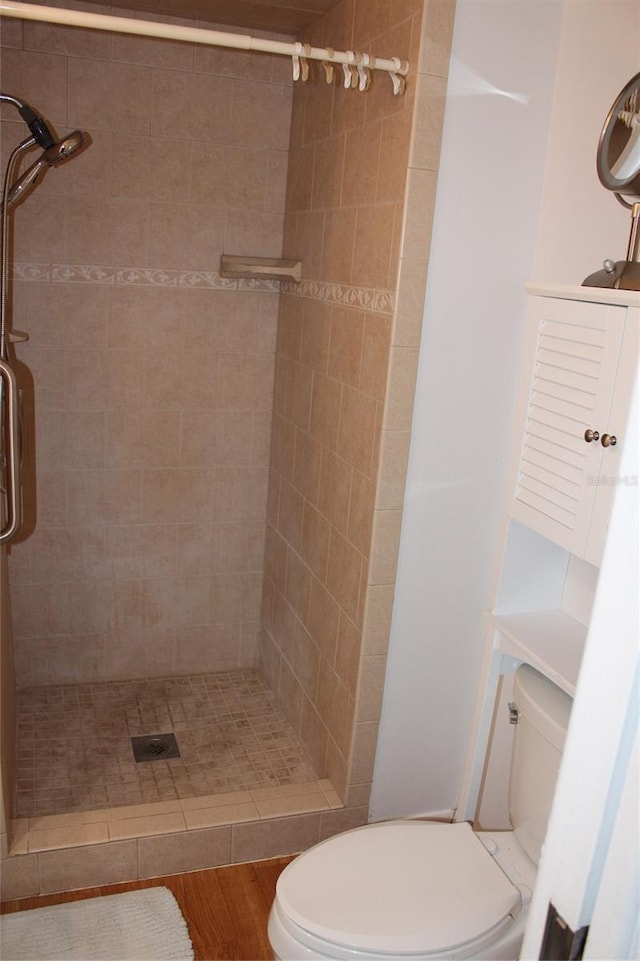 full bath featuring a stall shower and toilet