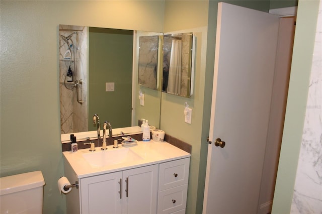 full bathroom with vanity, toilet, and walk in shower