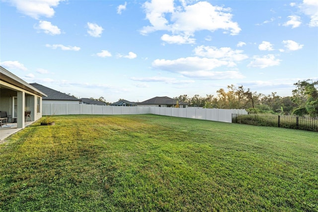 view of yard with a patio area and a fenced backyard