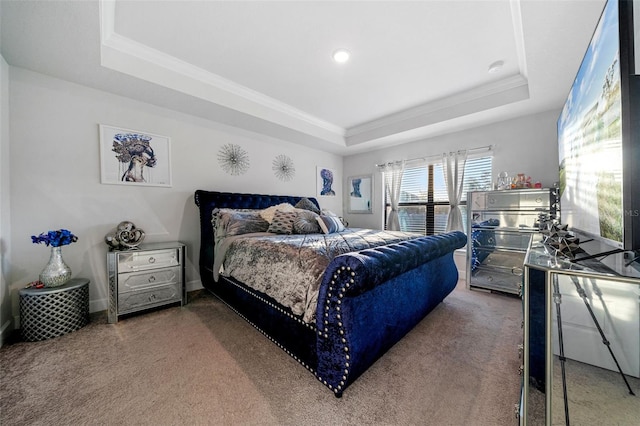 carpeted bedroom with crown molding, a raised ceiling, and baseboards