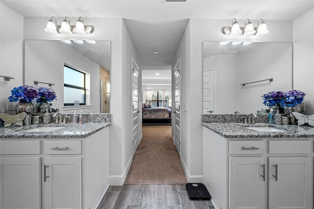 ensuite bathroom with a sink, two vanities, and ensuite bathroom