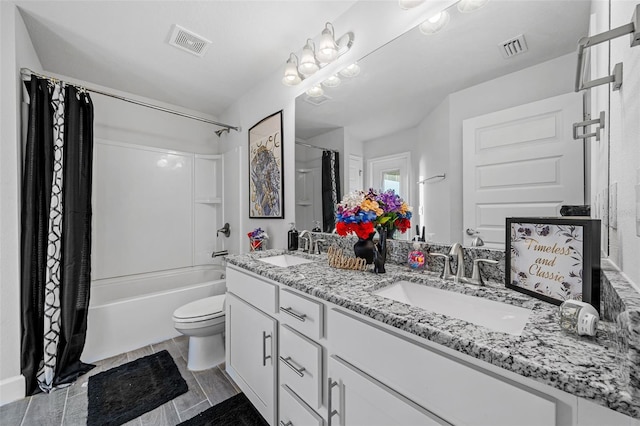 bathroom featuring visible vents, toilet, and a sink