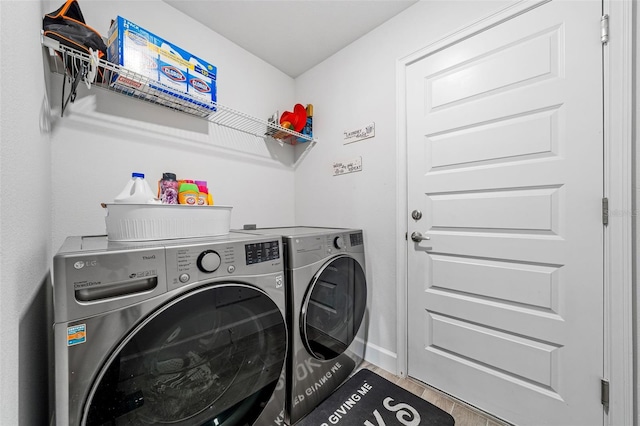 washroom with washing machine and clothes dryer and laundry area