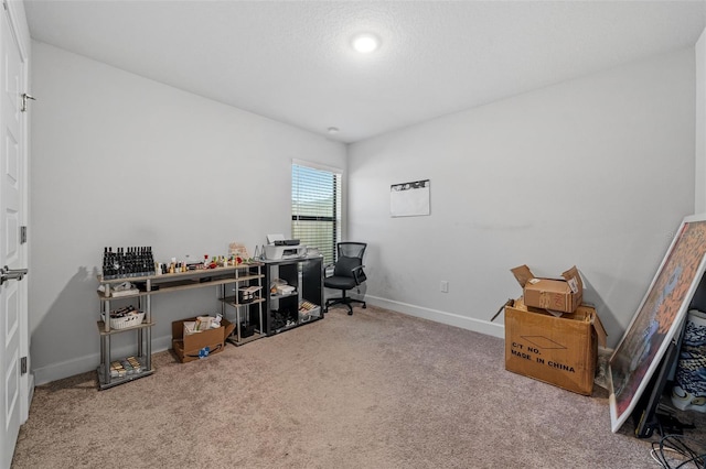 carpeted home office featuring baseboards