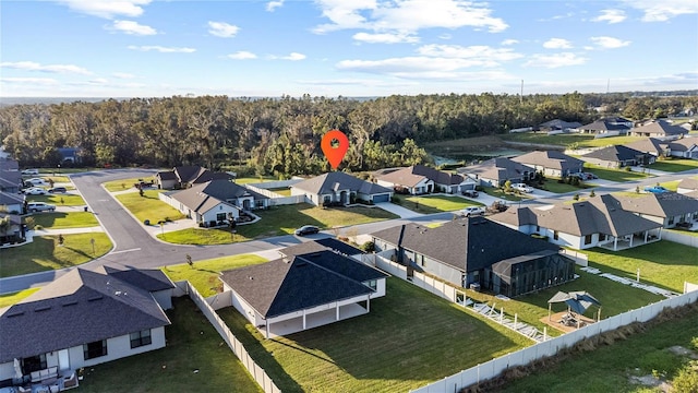 drone / aerial view with a residential view and a wooded view