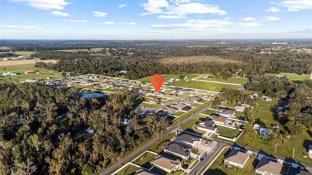 drone / aerial view with a residential view and a wooded view