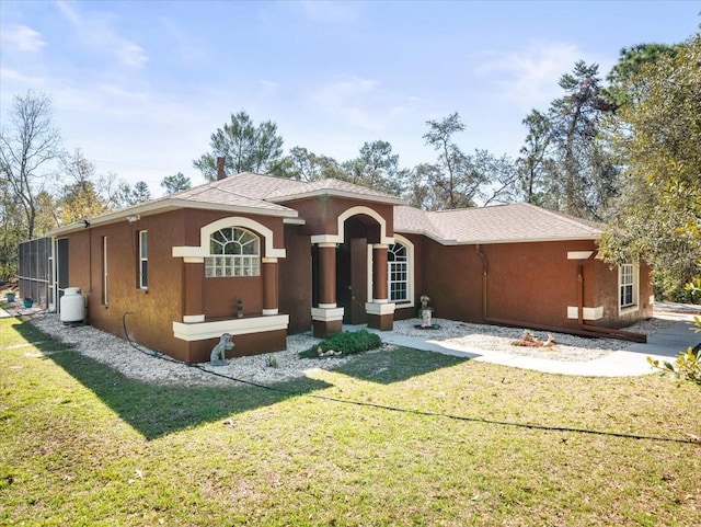 mediterranean / spanish-style home featuring stucco siding and a front yard