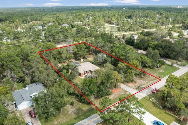 birds eye view of property with a forest view