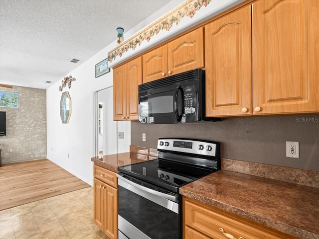 kitchen with visible vents, stainless steel range with electric stovetop, a textured ceiling, and black microwave