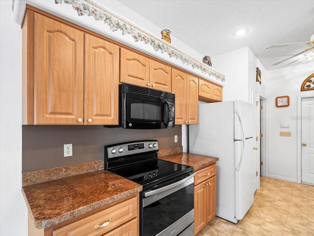 kitchen with stainless steel electric range oven, dark countertops, freestanding refrigerator, and black microwave