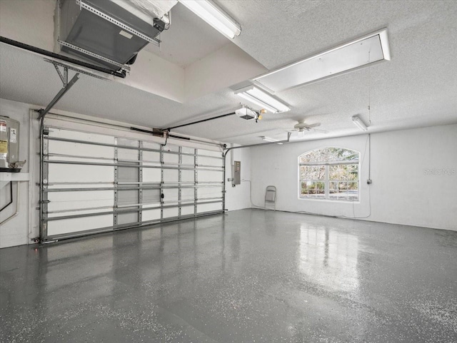 garage featuring electric panel and a garage door opener