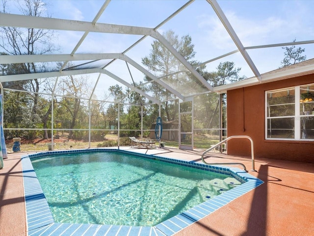 outdoor pool featuring glass enclosure and a patio