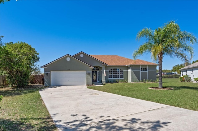 ranch-style house featuring a front yard, an attached garage, fence, and driveway