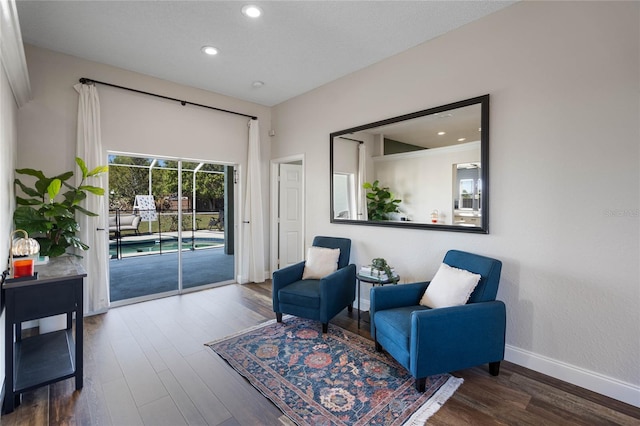 living area featuring recessed lighting, wood finished floors, and baseboards