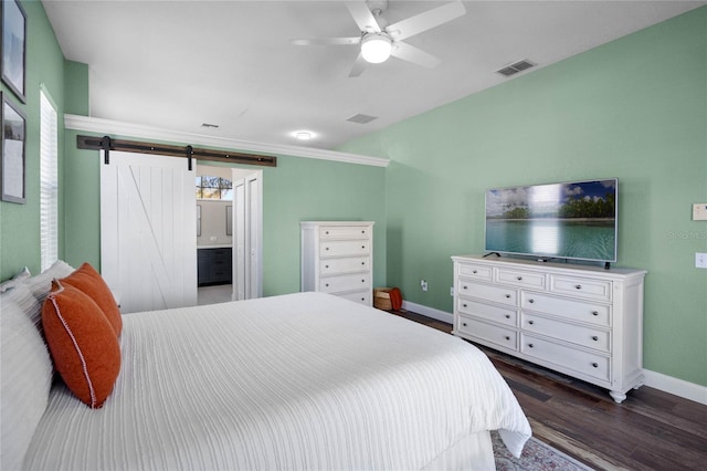 bedroom featuring baseboards, visible vents, dark wood finished floors, ceiling fan, and a barn door