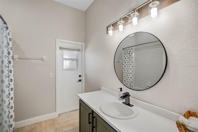 bathroom featuring baseboards, a shower with curtain, vanity, and tile patterned flooring