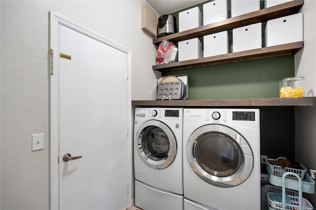 washroom with separate washer and dryer, laundry area, and a textured ceiling