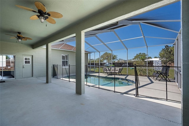 outdoor pool featuring a lanai, a ceiling fan, and a patio area