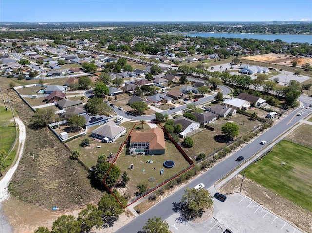 drone / aerial view featuring a residential view and a water view