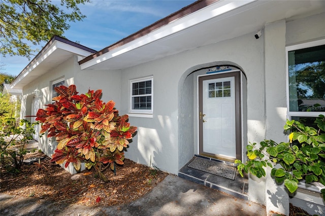 property entrance with stucco siding