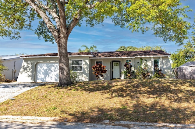 ranch-style house featuring stucco siding, driveway, and an attached garage