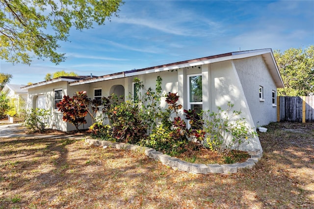 exterior space featuring fence and stucco siding