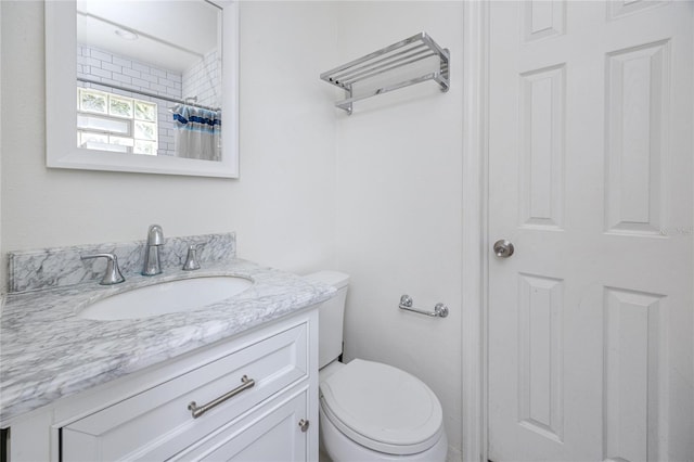 full bath with a shower with shower curtain, toilet, and vanity