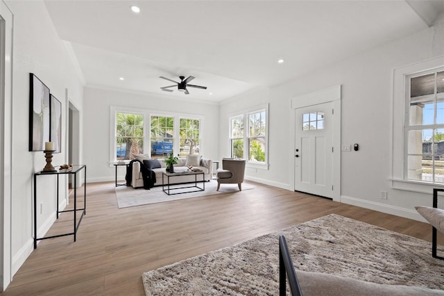 foyer featuring recessed lighting, baseboards, crown molding, and light wood-style floors