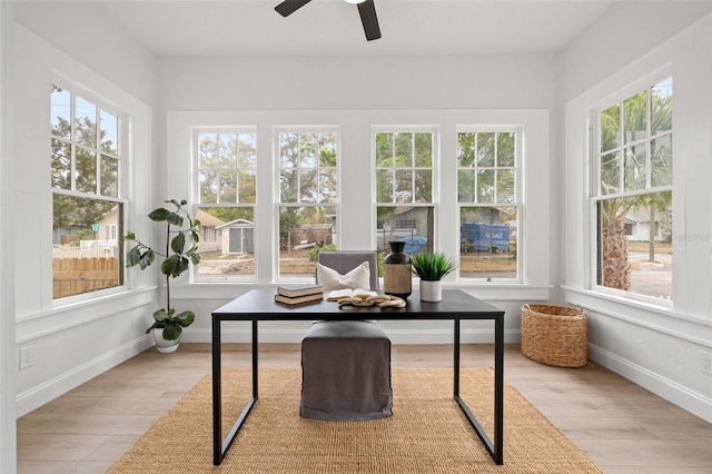 sunroom featuring a ceiling fan