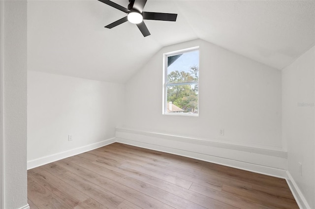 additional living space featuring baseboards, a ceiling fan, lofted ceiling, and wood finished floors