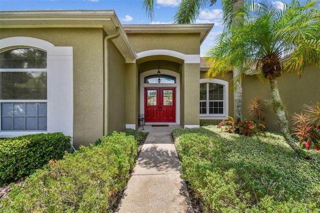 view of exterior entry with stucco siding