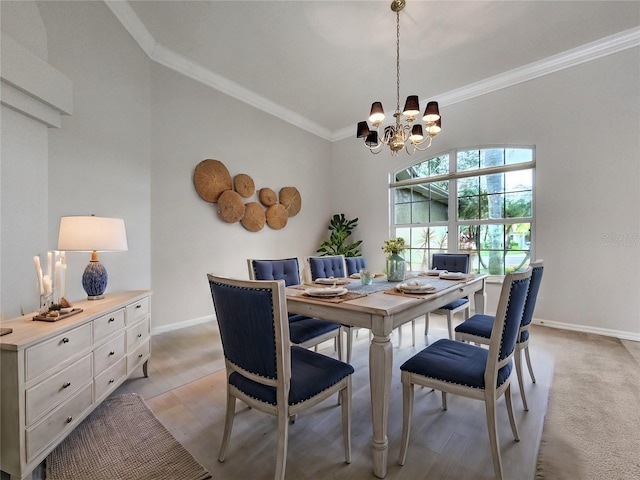 dining area with crown molding, light wood-style floors, baseboards, and a chandelier