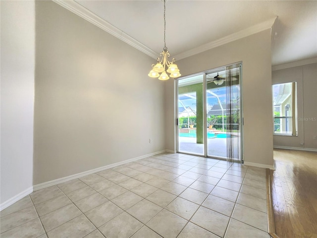 unfurnished room with baseboards, a notable chandelier, crown molding, and light wood finished floors