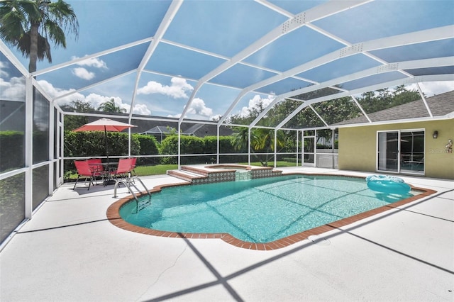 view of swimming pool featuring a patio, a lanai, and a pool with connected hot tub