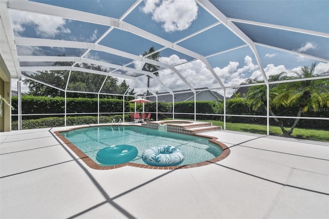 view of pool featuring glass enclosure, a pool with connected hot tub, and a patio area