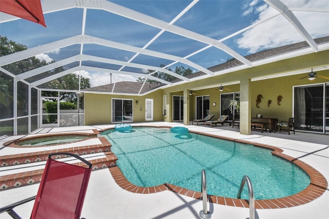 outdoor pool with a patio area, glass enclosure, an in ground hot tub, and a ceiling fan