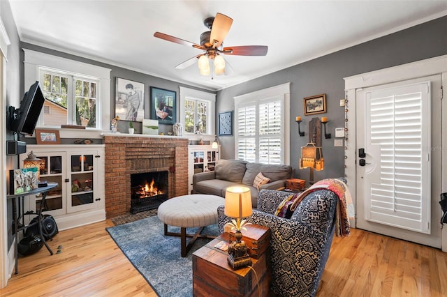 living room featuring wood finished floors, plenty of natural light, and ornamental molding