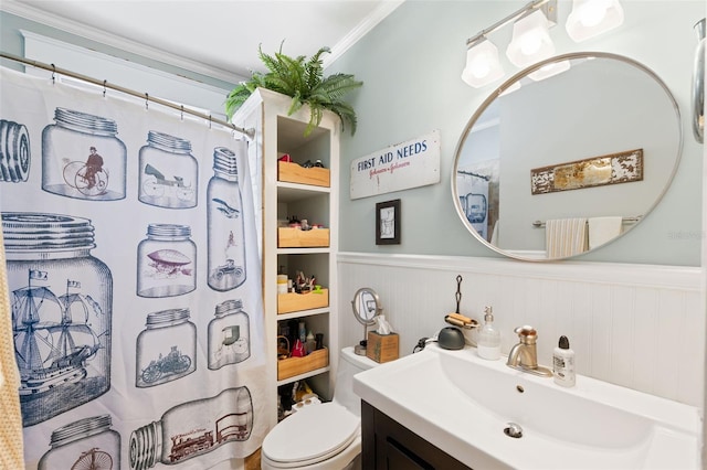 bathroom featuring vanity, toilet, a shower with curtain, and a wainscoted wall