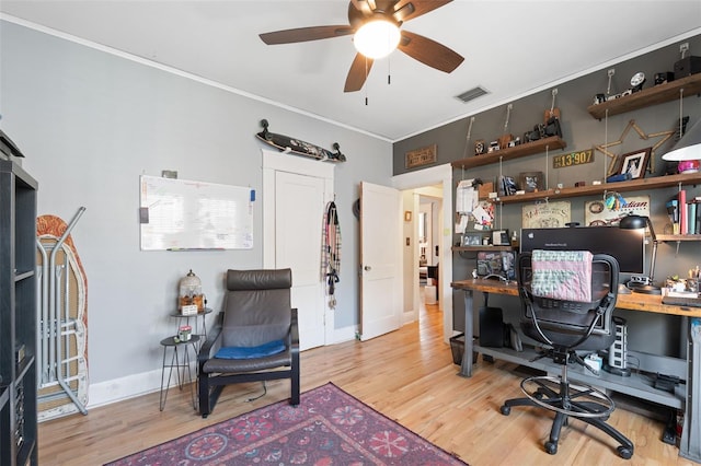 office with visible vents, baseboards, ceiling fan, ornamental molding, and wood finished floors