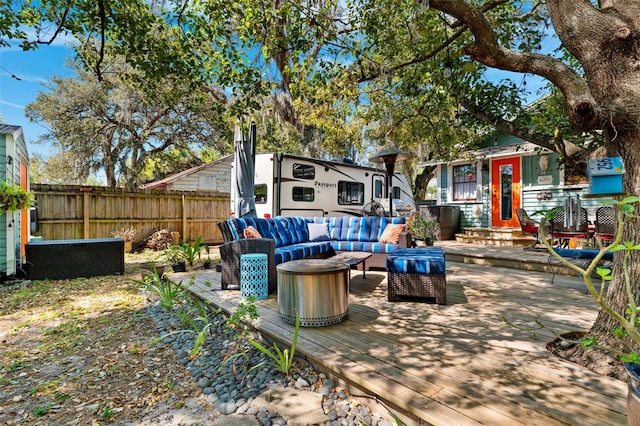 view of patio with a deck, fence, and an outdoor hangout area