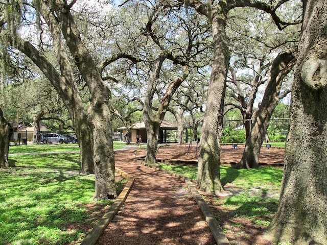 view of property's community with a lawn