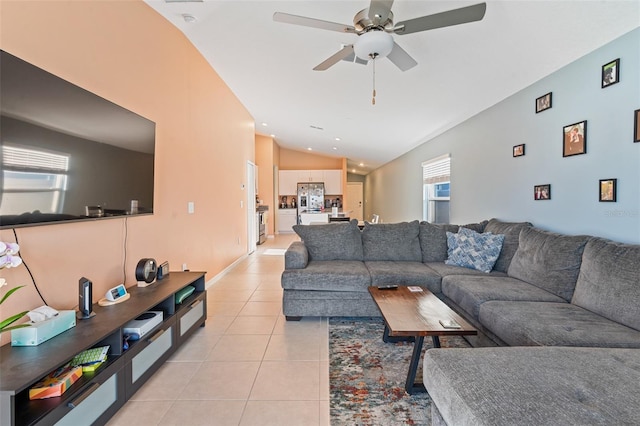 living room with light tile patterned floors, lofted ceiling, and a ceiling fan