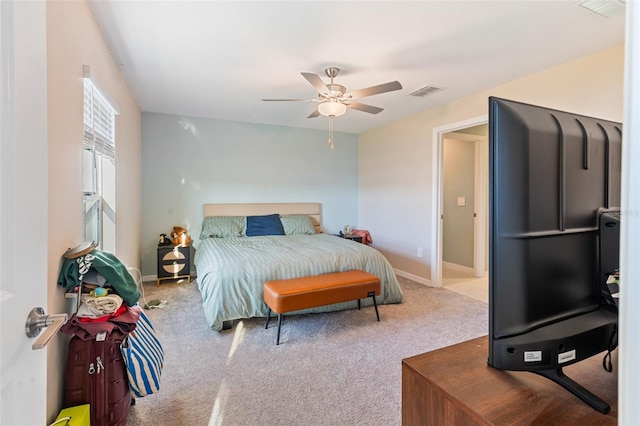 carpeted bedroom with baseboards, visible vents, and ceiling fan