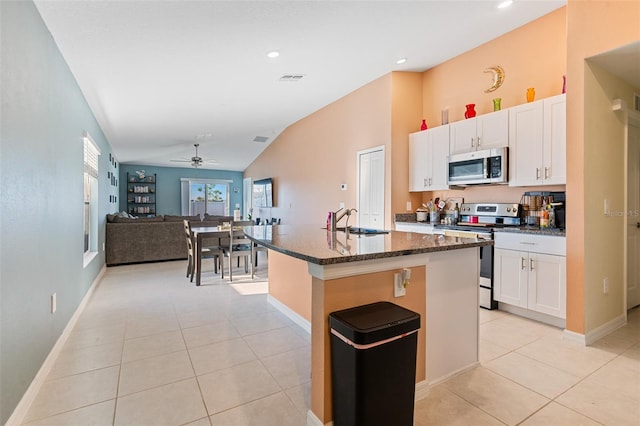 kitchen with ceiling fan, light tile patterned floors, a sink, and stainless steel appliances