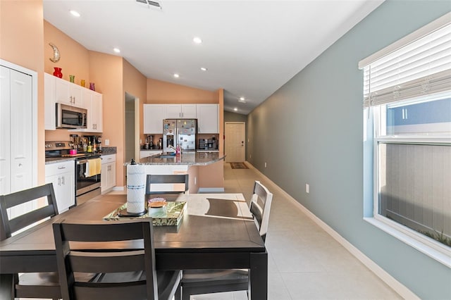 dining space with visible vents, lofted ceiling, recessed lighting, light tile patterned flooring, and baseboards