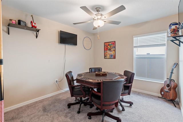 home office featuring baseboards, light carpet, and ceiling fan