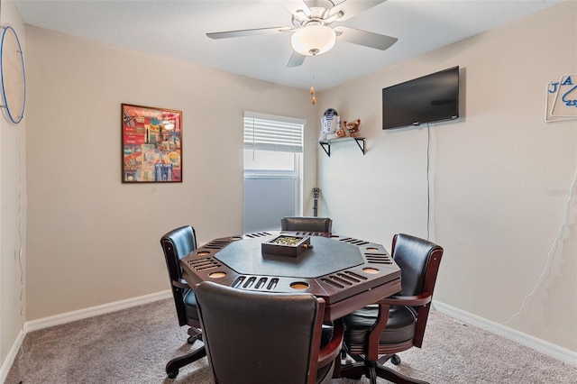 carpeted office space with baseboards and ceiling fan