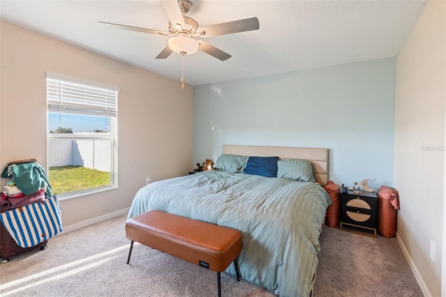 carpeted bedroom with baseboards and ceiling fan