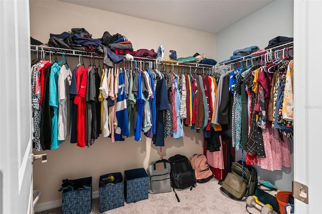 walk in closet with carpet flooring